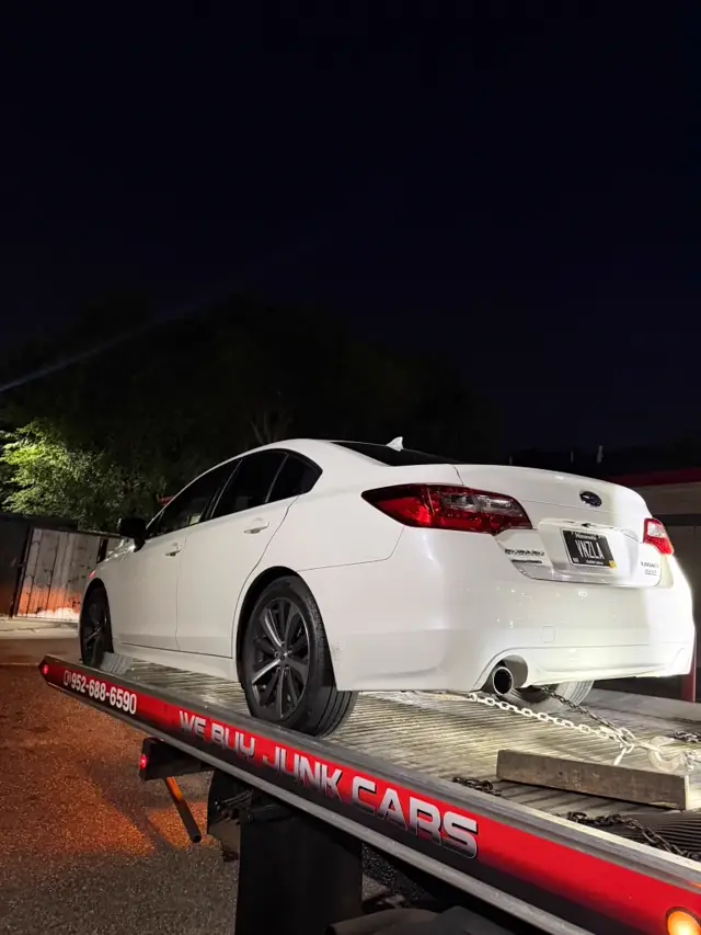 Sedan towing at night in Minnesota