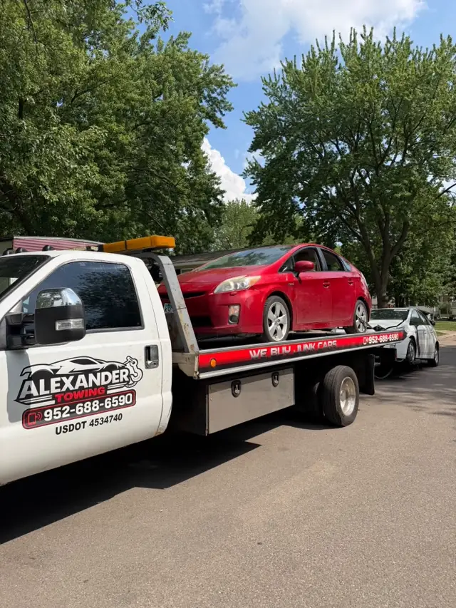 Red car flatbed towing in Minnesota