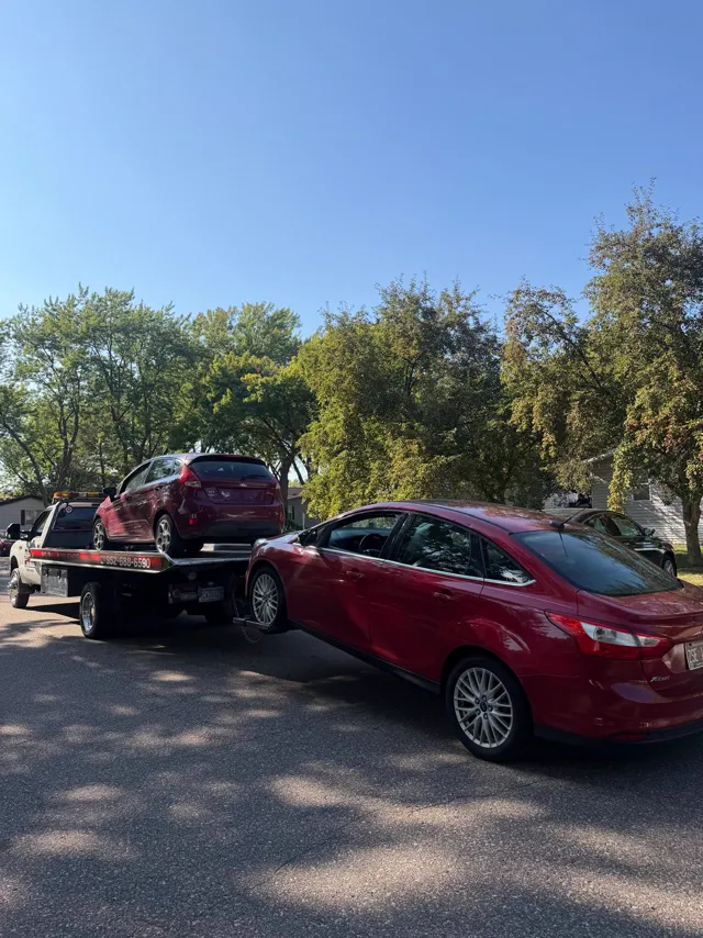 Ford Fiesta and Ford Focus towed on a residential street in the Twin Cities