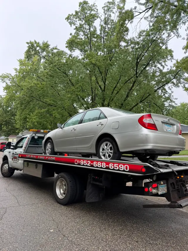 Toyota Camry on a flatbed tow truck in Minnesota