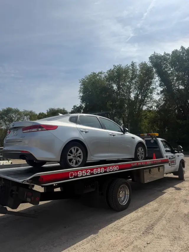 Kia Optima sedan recovered on a flatbed in the Twin Cities
